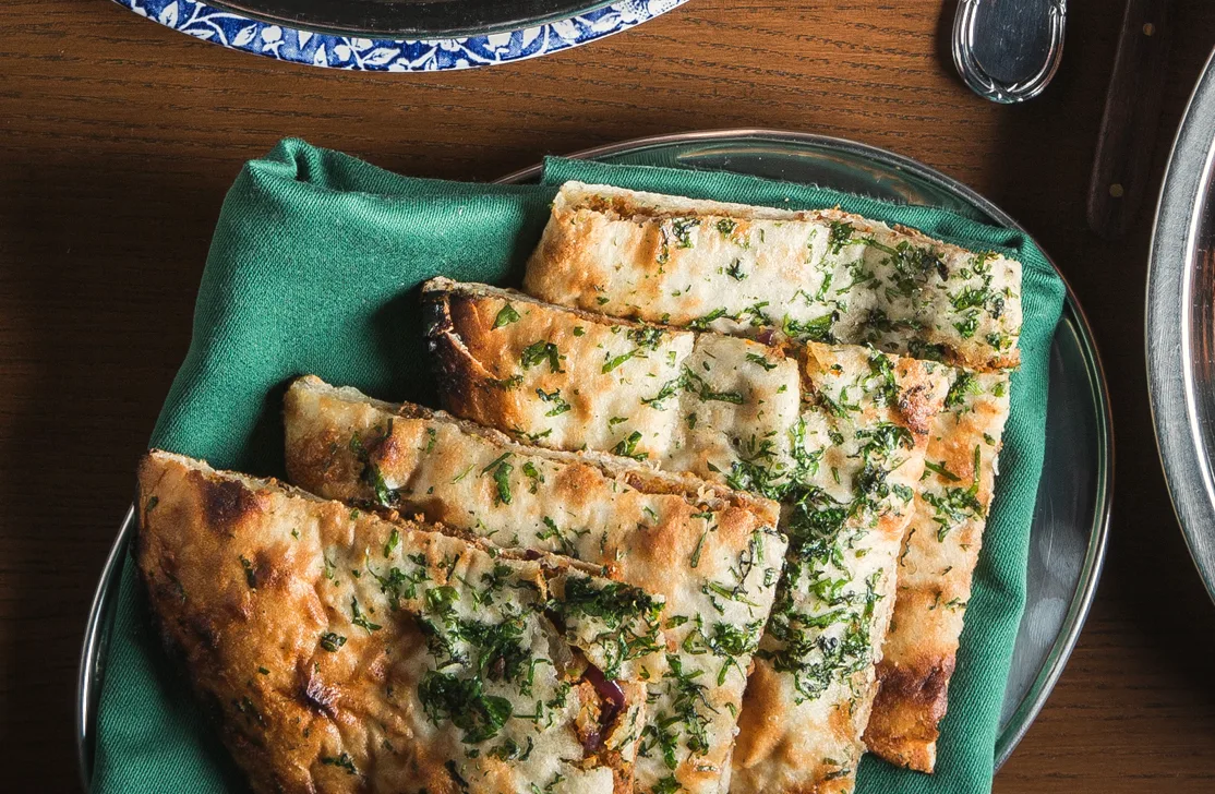 Garlic naan with coriander on a green napkin